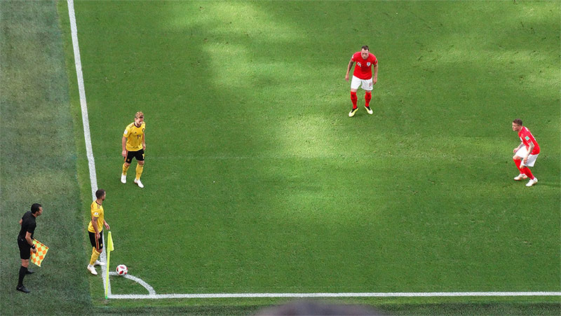 Eden Hazard of Belgium (left, yellow) has the option to play a short corner against England (red) at the 2018 FIFA World Cup.
